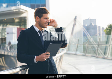 Businessman using a mobile phone and digital tablet Stock Photo