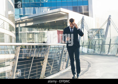Businessman using a mobile phone and digital tablet Stock Photo