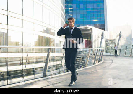 Businessman using a mobile phone and digital tablet Stock Photo