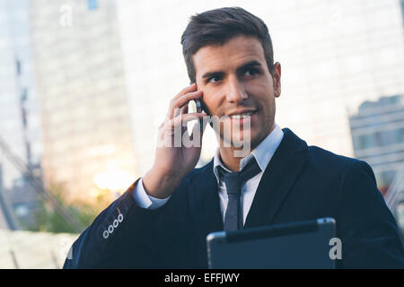 Businessman using a mobile phone and digital tablet Stock Photo