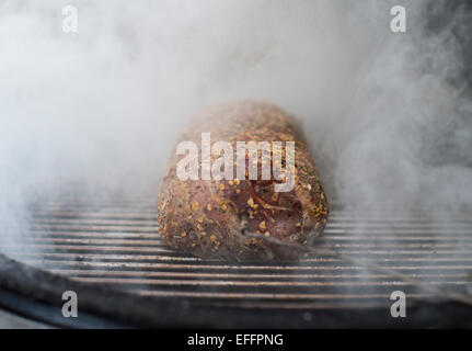 Bacon wrapped pork fillet on grill Stock Photo