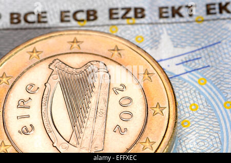 Irish Euro coin on a €5 note Stock Photo