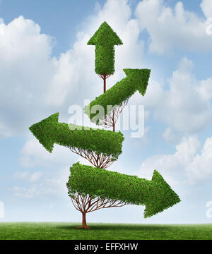 Recovery and success business concept as an arrow tree pointing downward gradually recovering with upward pointing branches as a symbol for financial and economic achievement. Stock Photo