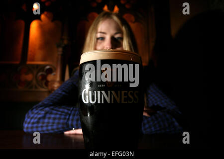 A woman with a pint of Guinness beer Stock Photo