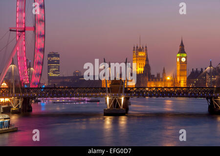 Big Ben Houses of Parliament, Hungerford Bridge and London Eye at twilight dusk night Westminster London England UK Stock Photo