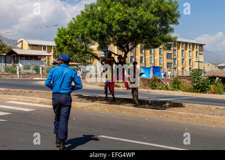 A Policeman Crosses The Road To Speak To A Group Of Boys, Arba Minch, Ethiopia Stock Photo