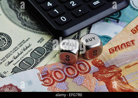 US dollar Russian ruble banknotes, dices cubes with the words SELL BUY, calculator. Selective focus Stock Photo