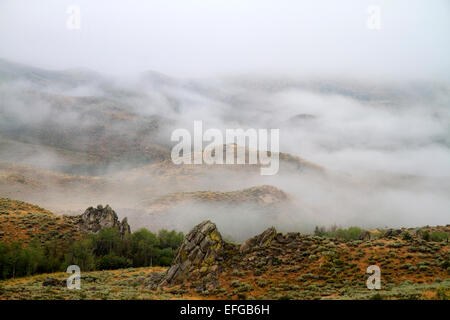 Fog blanketing the mountains along US 20 in Elmore County, Idaho, USA. Stock Photo