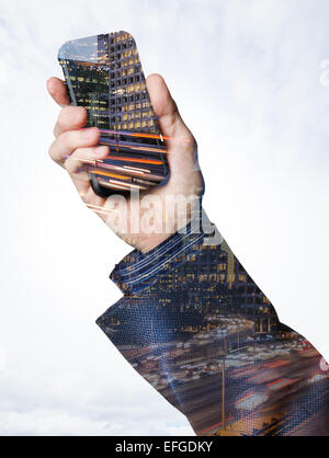 Hand holding a smart phone with city lights Stock Photo