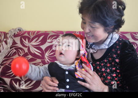 6-8 months cute baby playing with grandmother,indoors Stock Photo