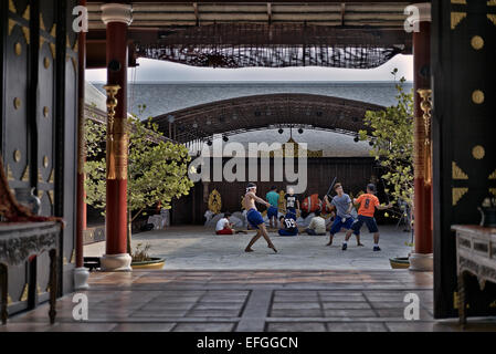 Martial arts, Thailand temple with participants practicing the ancient martial art of Krabi Krabong stick fighting. Thailand S. E. Asia Stock Photo