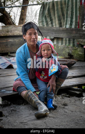 Grandmother and grandchild; grandmother wearing yak hair hat, both from Monpa tribe in village Tawang district Arunachal Pradesh Stock Photo