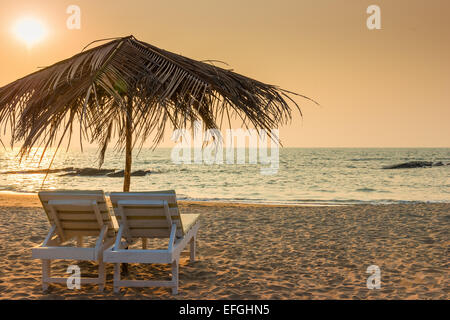 beautiful empty beach and a pair of sun loungers Stock Photo