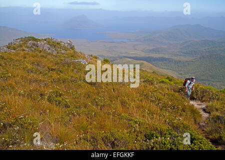 Hiker above Lake Pedder on the trail to Mt Anne, the highest peak in south west Tasmania Stock Photo