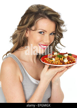 Healthy Young Woman Eating a Pasta Salad Stock Photo