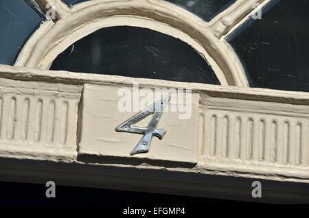 The number 4 above a the entrance to a house Stock Photo