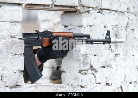 Kalashnikov rifle in the window Stock Photo