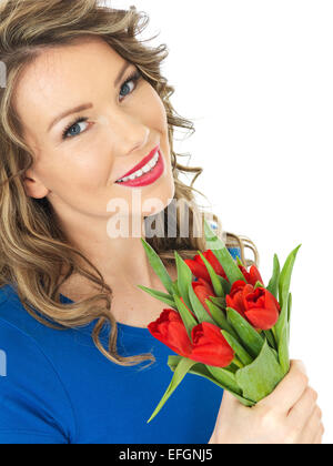 Attractive Woman Holding a Bunch of Tulips Stock Photo