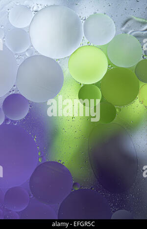Purple, Green Gradient Oil drops in the water -abstract background Stock Photo