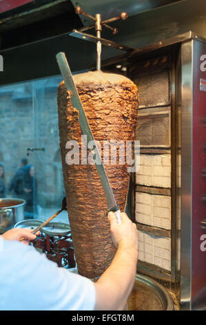 Chef cutting with doner knife Traditional Turkish Doner Kebab meat ...