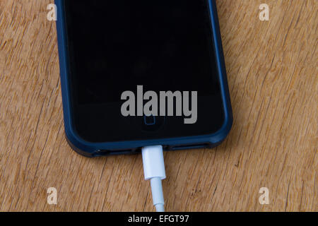 Apple iPhone mobile phone being charged Stock Photo