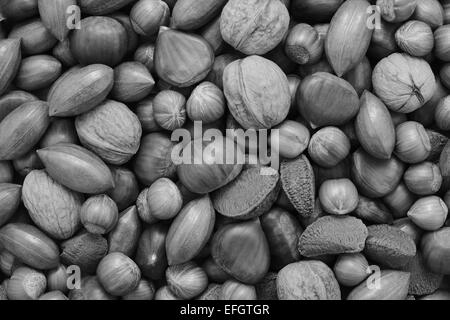 Mixed nuts - chestnuts, pecans, walnuts, brazils and hazelnuts - as an abstract background texture Stock Photo