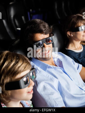Family Watching 3D Movie In Theater Stock Photo