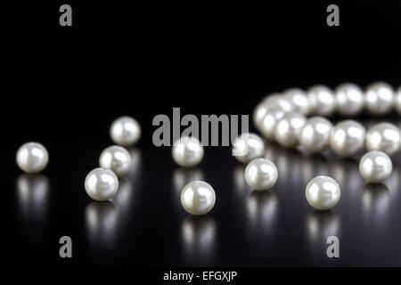 White pearls necklace on black background Stock Photo