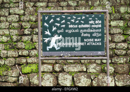 Funny sign but warning that noise may provoke hornet attack at Lion Rock Sigiriya,Sri Lanka,rock,unesco,cave,art,fresco, Stock Photo