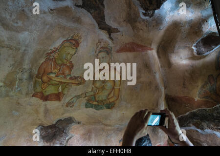 Ancient frescoes of maidens on cave wall at Sigiriya Rock Fortress, Sigiriya, Sri Lanka,Sigiriya,Sri Lanka,rock,unesco,cave,art Stock Photo