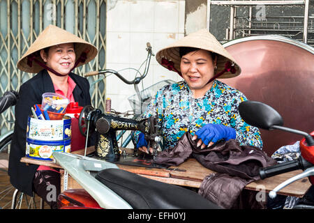 Street tailor women altering clothes in Kon Tum, Vietnam Stock Photo