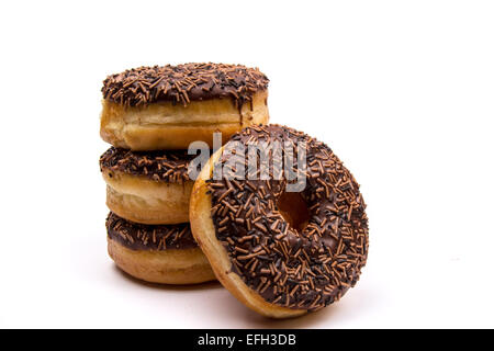 A pile of chocolate iced ring donuts on a white background Stock Photo