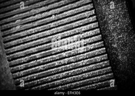 Detail of perforated industrial machine component in biomass plant, black & white close up Stock Photo