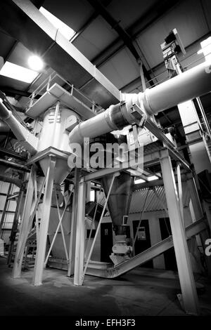 Industrial machinery and piping for production of biomass fuel, black & white Stock Photo