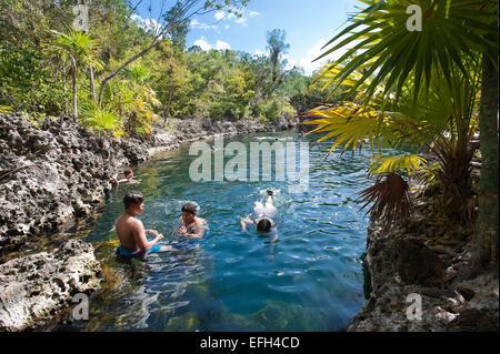 Horizontal view of tourists enjoying the cool water at Cueva de los Peces (Fish Cave) in Cuba. Stock Photo