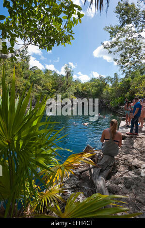 Vertical view of tourists enjoying the cool water at Cueva de los Peces (Fish Cave) in Cuba. Stock Photo