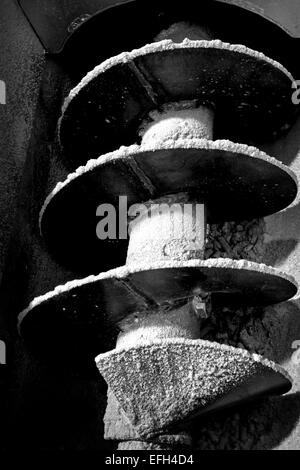 Detail of spiral industrial machine component in biomass plant, black & white close up Stock Photo