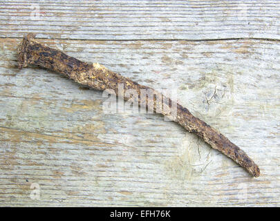 Old and rusty nail isolated on wood background Stock Photo