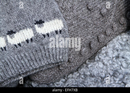 Grey sheep wool knitwear on agricultural show market stall, close up Stock Photo
