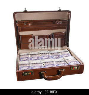 Attache case or briefcase full of UK British banknotes on a white background Stock Photo