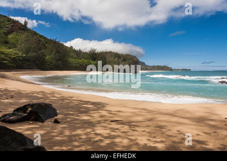 Isolated Beach swept deeply by the waves. A round and protected bay at the end of Lumaha'i Beach on the north coast. Stock Photo