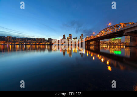 Portland Oregon Downtown City Skyline Along Willamette River by the Hawthorne Bridge at Evening Blue Hour Stock Photo