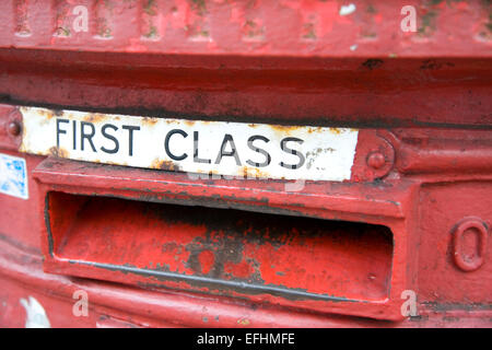 British first class mail box slot in old traditional red pillar box Stock Photo