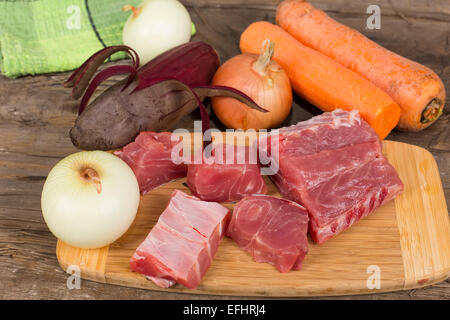 fillet of carp with vegetables on the table with old rotten boards Stock Photo