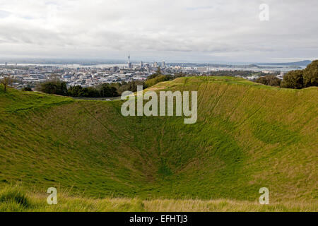 Auckland skyline seen from Mount Eden and view into the grass-covered volcano crater, Auckland, North Island, New Zealand Stock Photo