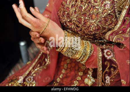 Close up of A bride preparing for her wedding day in traditional Muslim wedding dress and bangles. Stock Photo