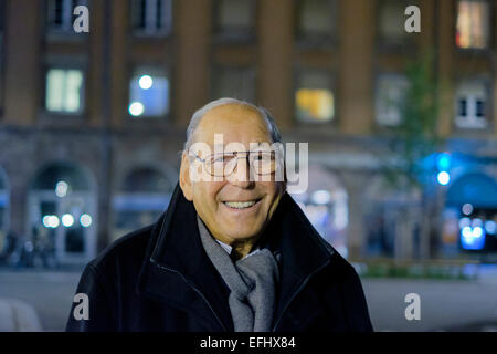 Smiling elderly man 80s portrait at night Stock Photo