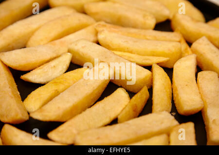 frozen oven chips laid out on a baking tray Stock Photo