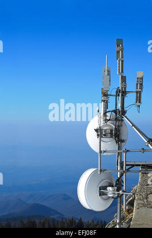 telecommunication antennas group on mountain top Stock Photo