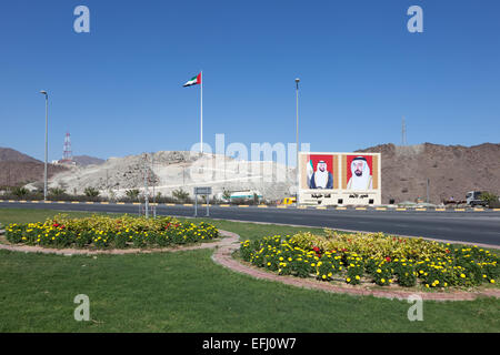 Roundabout in Fujairah with national flag and portraits of the rulers of the UAE Stock Photo